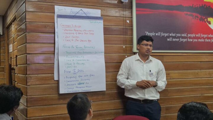 A facilitator leading an accountability-focused leadership training session during a DimenZion3 workshop.