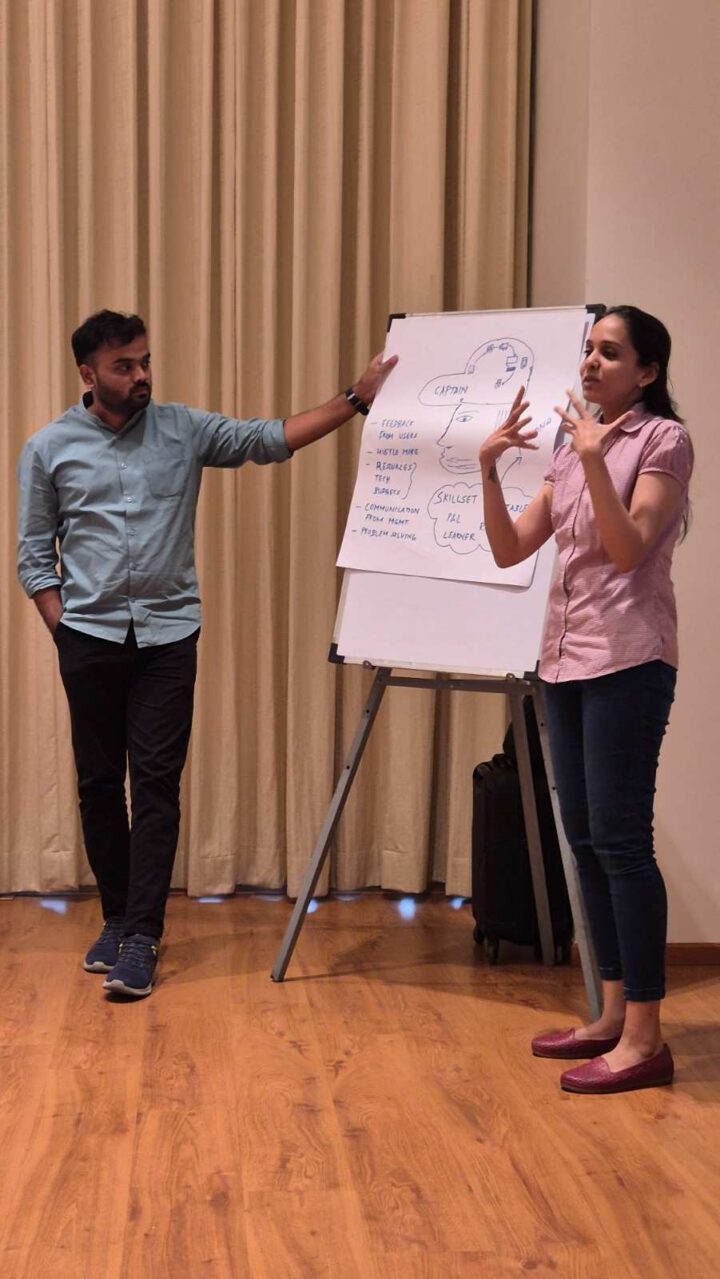 Facilitators leading a communication and leadership skills training session using a flipchart at DimenZion3.