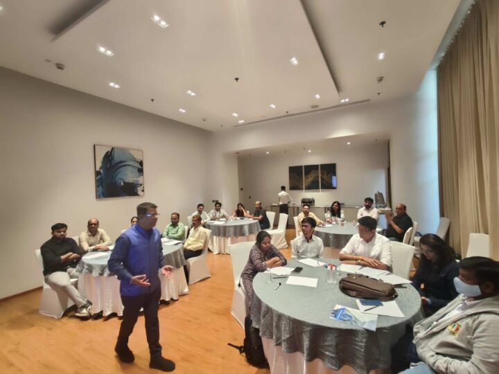 DimenZion3 leadership training session with participants at round tables