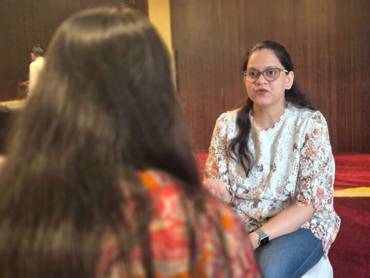 A facilitator conducting a one-on-one executive coaching conversation during a DimenZion3 leadership program.