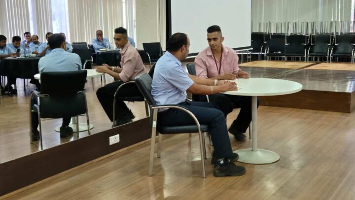 Participants engaged in a leadership coaching partner activity during a corporate training workshop.
