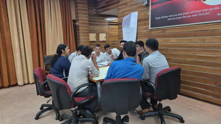 Participants collaborating during a leadership and team discussion workshop conducted by DimenZion3.
