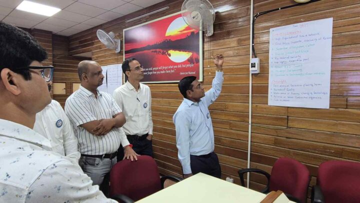 A facilitator presenting leadership workshop insights using a flipchart during a DimenZion3 training session.