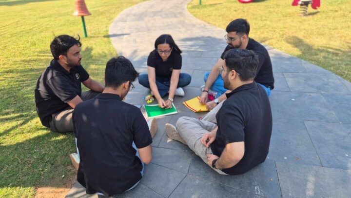 Employees brainstorming together during an outdoor team activity