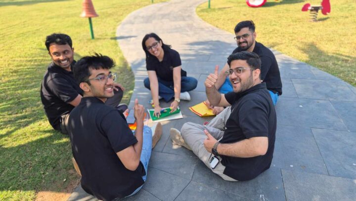 Team members smiling during an outdoor team-building session