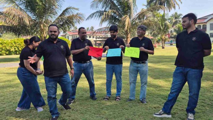 Team presenting creative activity results during an outdoor workshop